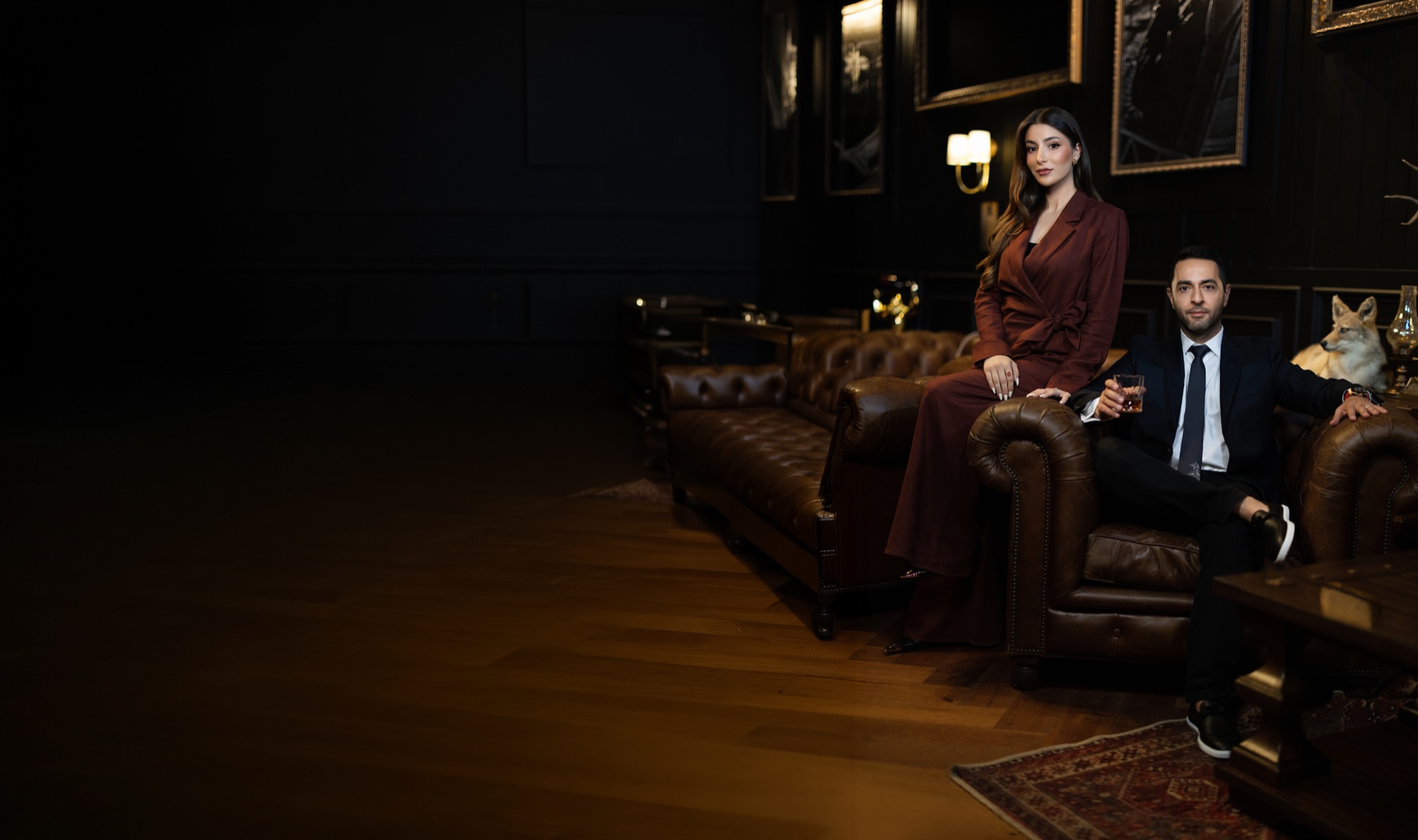 Hovanes and Shushanik Margarian seated in a dark leather lounge